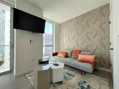 a living room with a couch and a tv at 227-2212AM DOWNTOWN MIAMI STUDIO in Miami