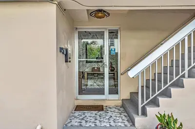 a staircase leading to a house with a glass door at Bay Harbor Sunset Apt 4A in Miami Beach