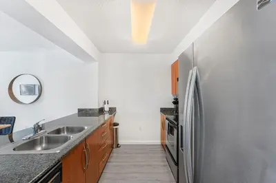 a kitchen with a stainless steel refrigerator at Stylish Brickell Condo with Stunning Views & Premier Amenities in Miami