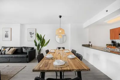a living room with a wooden table and a couch at Stylish Brickell Condo with Stunning Views & Premier Amenities in Miami