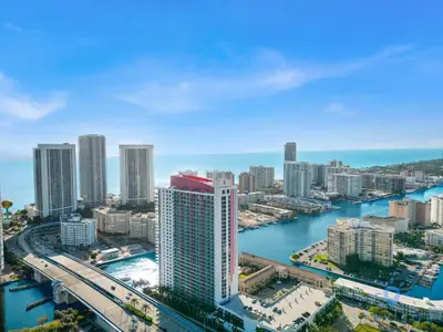 an aerial view of a city with a river and buildings at Stylish Beach Apartment with Pool in Hallandale Beach