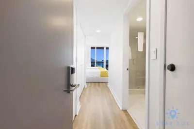 a hallway with a door leading to a bedroom at Amazing Studio Near the Beach in Hallandale Beach