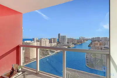 a balcony with a view of the water in a city at Amazing Studio Near the Beach in Hallandale Beach