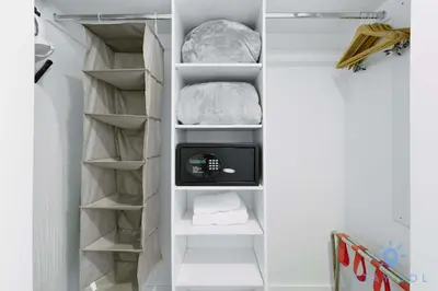 a walk in closet with a tv and shelves at Amazing Studio Near the Beach in Hallandale Beach
