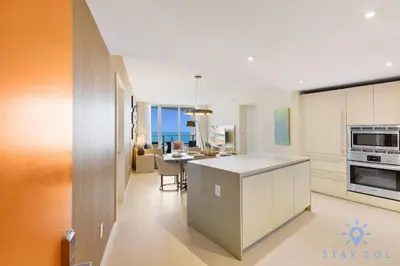 a kitchen and dining room with an open floor plan at Apartment with Ocean View Balcony in Hollywood