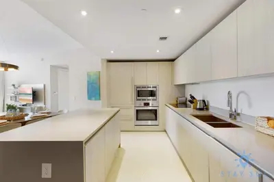 a large kitchen with white cabinets and appliances at Apartment with Ocean View Balcony in Hollywood