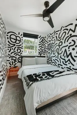 a bedroom with a black and white patterned wall at Miami Oasis - Unit A in Miami