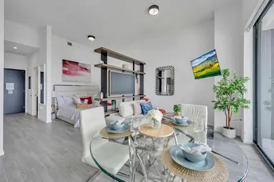 a living room with a glass table and chairs at City Views Studio Downtown Miami in Miami