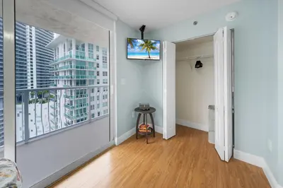 a living room with white walls and a large window at Oceanview Haven Spacious Inviting for 8 Guests in Miami