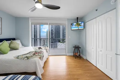 a bedroom with a bed and a tv on the wall at Oceanview Haven Spacious Inviting for 8 Guests in Miami