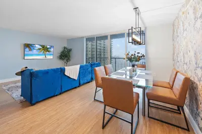 a living room with a blue couch and a table at Oceanview Haven Spacious Inviting for 8 Guests in Miami