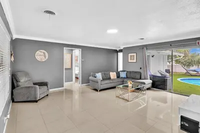 a living room with a couch and a table at Luxury Heated Pool Villa Hollywood Beach & Casino in Hollywood