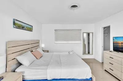 a white bedroom with a bed and a television at Luxury Heated Pool Villa Hollywood Beach & Casino in Hollywood