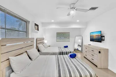 a bedroom with two beds and a dresser at Luxury Heated Pool Villa Hollywood Beach & Casino in Hollywood