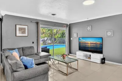 a living room with a couch and a tv at Luxury Heated Pool Villa Hollywood Beach & Casino in Hollywood