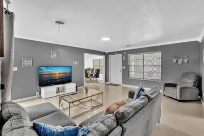 a living room with two couches and a flat screen tv at Luxury Heated Pool Villa Hollywood Beach & Casino in Hollywood