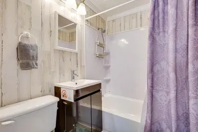 a bathroom with a toilet and a sink and a shower at Shared Pool and Backyard Small and Cozy Guest House in Fort Lauderdale