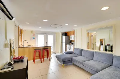 a living room with a couch and a kitchen at Detached Backyard Studio in Fort Lauderdale! in Fort Lauderdale