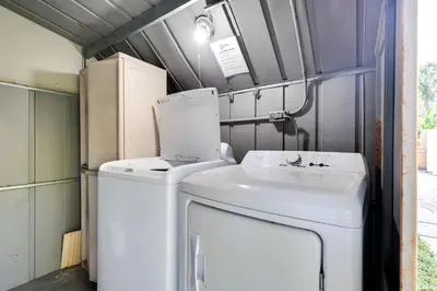 a washing machine and a sink in a trailer at Detached Backyard Studio in Fort Lauderdale! in Fort Lauderdale