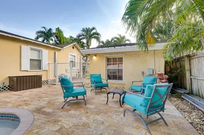 a patio with blue chairs and a pool at Detached Backyard Studio in Fort Lauderdale! in Fort Lauderdale