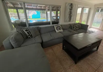a living room with a couch and a coffee table at Turtle Nest Bungalow in Fort Lauderdale
