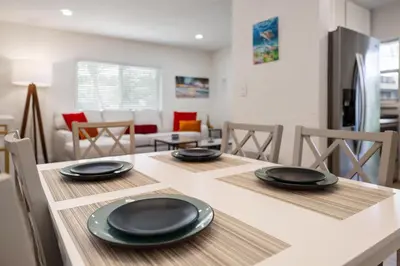 a kitchen with a table with black plates on it at Turtle Nest Bungalow in Fort Lauderdale