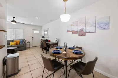 a living room with a dining room table and chairs at Turtle Nest Bungalow in Fort Lauderdale