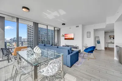 a living room with a blue couch and a table at Great 3 beds 3 baths Appartment Downtown Miami in Miami