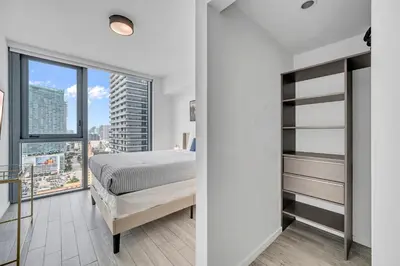 a bedroom with a bed and a large window at Great 3 beds 3 baths Appartment Downtown Miami in Miami
