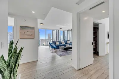 a living room with white walls and a blue couch at Great 3 beds 3 baths Appartment Downtown Miami in Miami