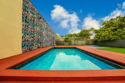 a swimming pool with a mural on the side of a house at Prime Location 4BR Villa with Pool in Miami
