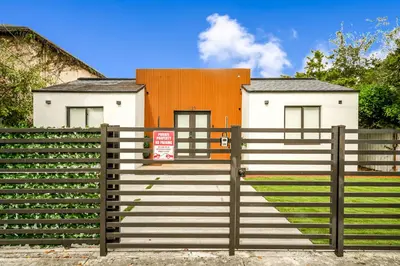 a fence with a staircase in front of a house at Prime Location 4BR Villa with Pool in Miami
