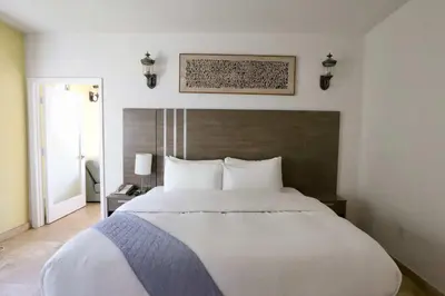 a large white bed in a bedroom with at Art Deco 1 Bedroom Apartment Steps to Beach in South of Fifth Neighborhood in Miami Beach