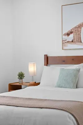 a bedroom with a bed and a table with a lamp at 921 Apartment 1 in Fort Lauderdale