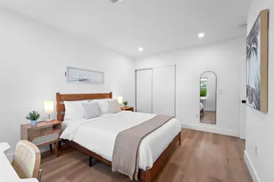 a white bedroom with a large bed and a table at 921 Apartment 2 in Fort Lauderdale