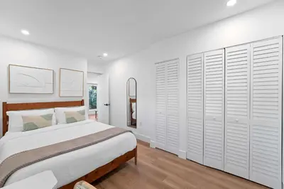 a bedroom with a bed and a wall of closets at 921 Apartment 3 in Fort Lauderdale