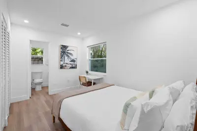 a white bedroom with a bed and a desk at 921 Apartment 3 in Fort Lauderdale