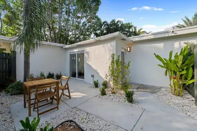 a patio with a table and chairs in front of a house at 921 Apartment 4 in Fort Lauderdale