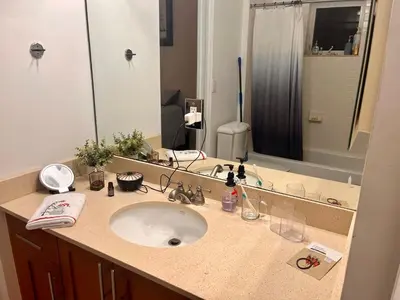 a bathroom with a sink and a large mirror at Two private rooms with private bathroom in shared House in Fort Lauderdale