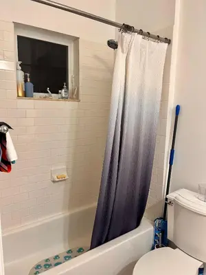 a bathroom with a shower curtain and a toilet at Two private rooms with private bathroom in shared House in Fort Lauderdale