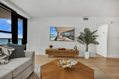 a living room with a couch and a table at Chic 2-Bedroom Condo with Beach Service & Gym / 1210 in Miami Beach