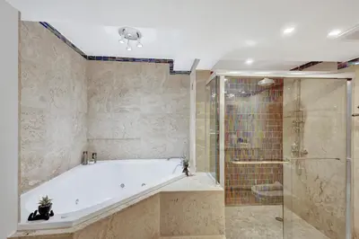 a large bathroom with a tub and a shower at Stunning 2-Bedroom Condo with Beach Service 614 in Miami Beach