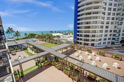 an overhead view of a building with tables and chairs at Ocean View Spacious 2 BDR Condo Beach Service 609 in Miami Beach