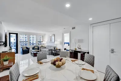 a dining room and living room with a table and chairs at Ocean View Spacious 2 BDR Condo Beach Service 609 in Miami Beach