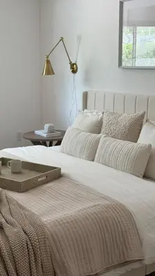a bedroom with a large white bed with a table at POOL & BBQ with the family in Biscayne Park
