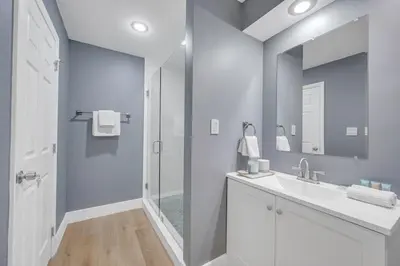 a white bathroom with a sink and a shower at POOL & BBQ with the family in Biscayne Park