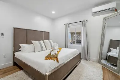 a bedroom with a large bed and a large window at Casa Roselle 3 Bedrooms in Hollywood