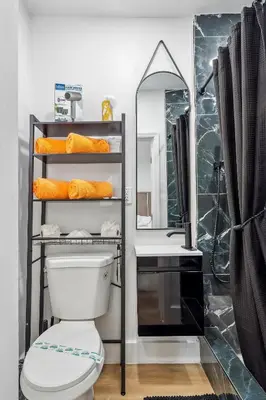a bathroom with a toilet and a sink and a mirror at Casa Roselle 3 Bedrooms in Hollywood