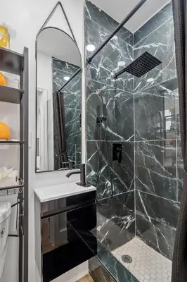 a bathroom with a shower with a sink and a mirror at Casa Roselle 3 Bedrooms in Hollywood