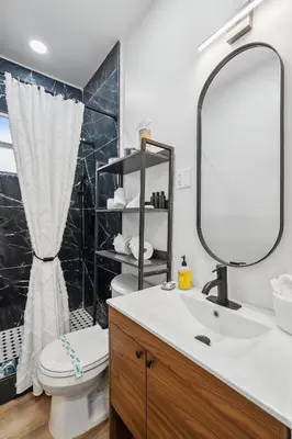 a bathroom with a sink and a toilet and a mirror at Casa Roselle 3 Bedrooms in Hollywood